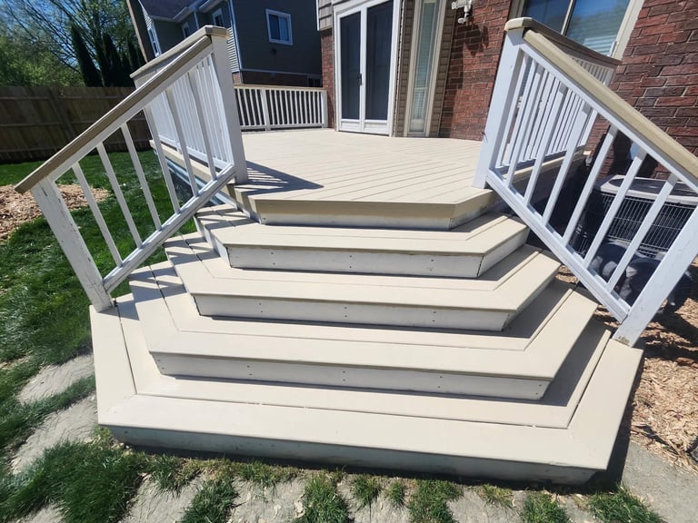 Wide deck with light gray composite boards and white railings by Central Ohio Deck Staining