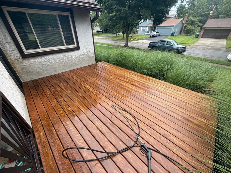 Wooden deck attached to brick house with fresh staining by Central Ohio Deck Staining