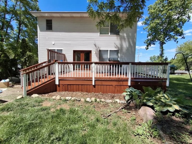 Two-story white house with brown and white deck and wooden ramp by Central Ohio Deck Staining