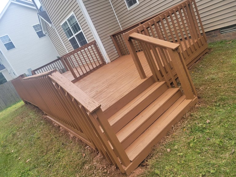 Brown wooden deck with stairs and railing by Central Ohio Deck Staining